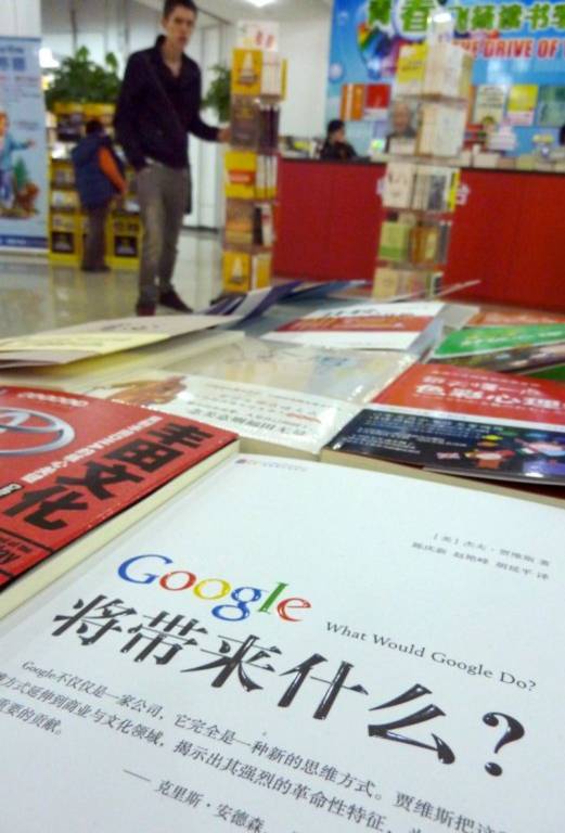 A shopper browses a display as a book named